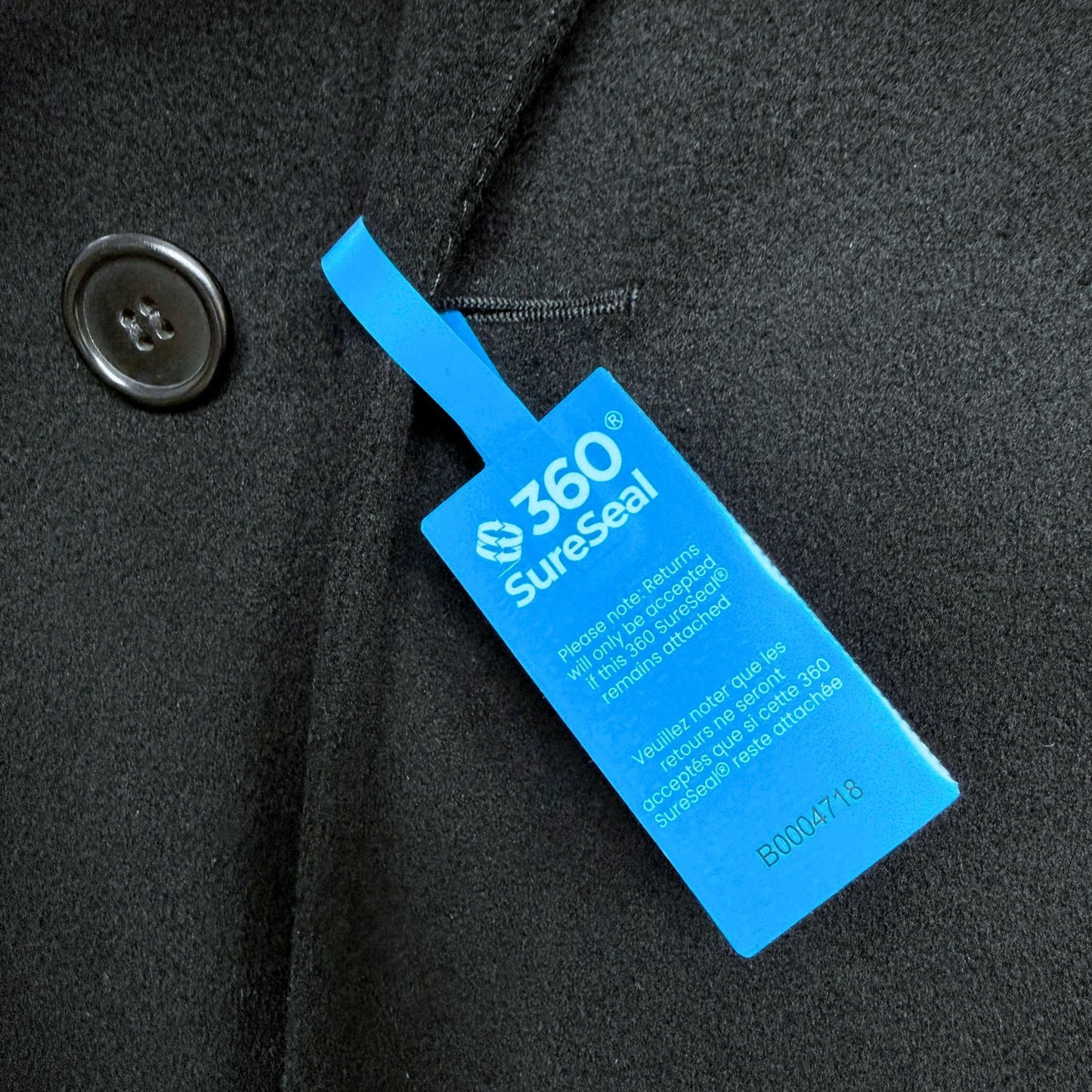 tamper-evident return integrity seal attached to coat buttonhole 360 SureSeal large prevents wear and return fraud