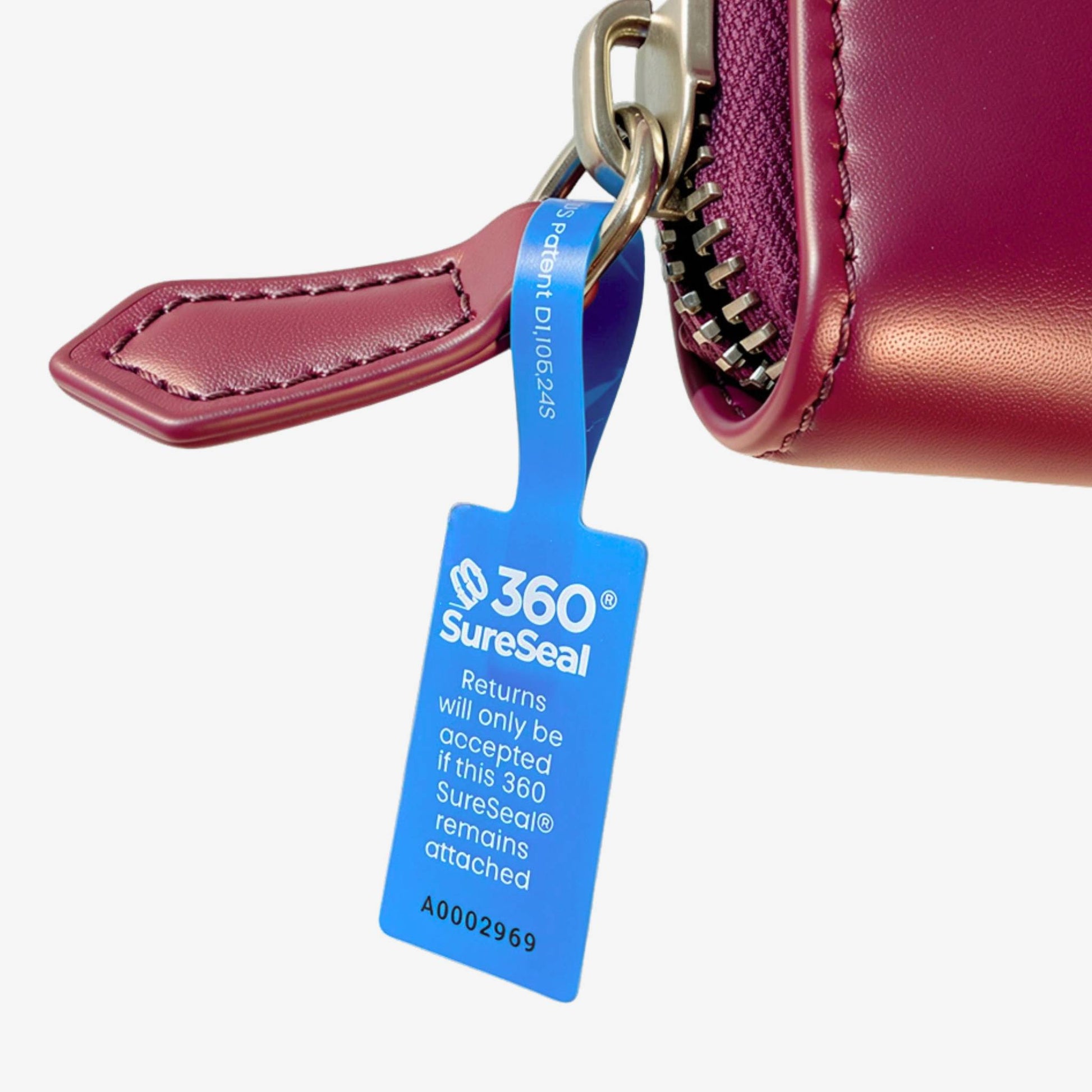 360 SureSeal small tamper-evident return integrity tag attached to handbag zipper pull for return fraud prevention
