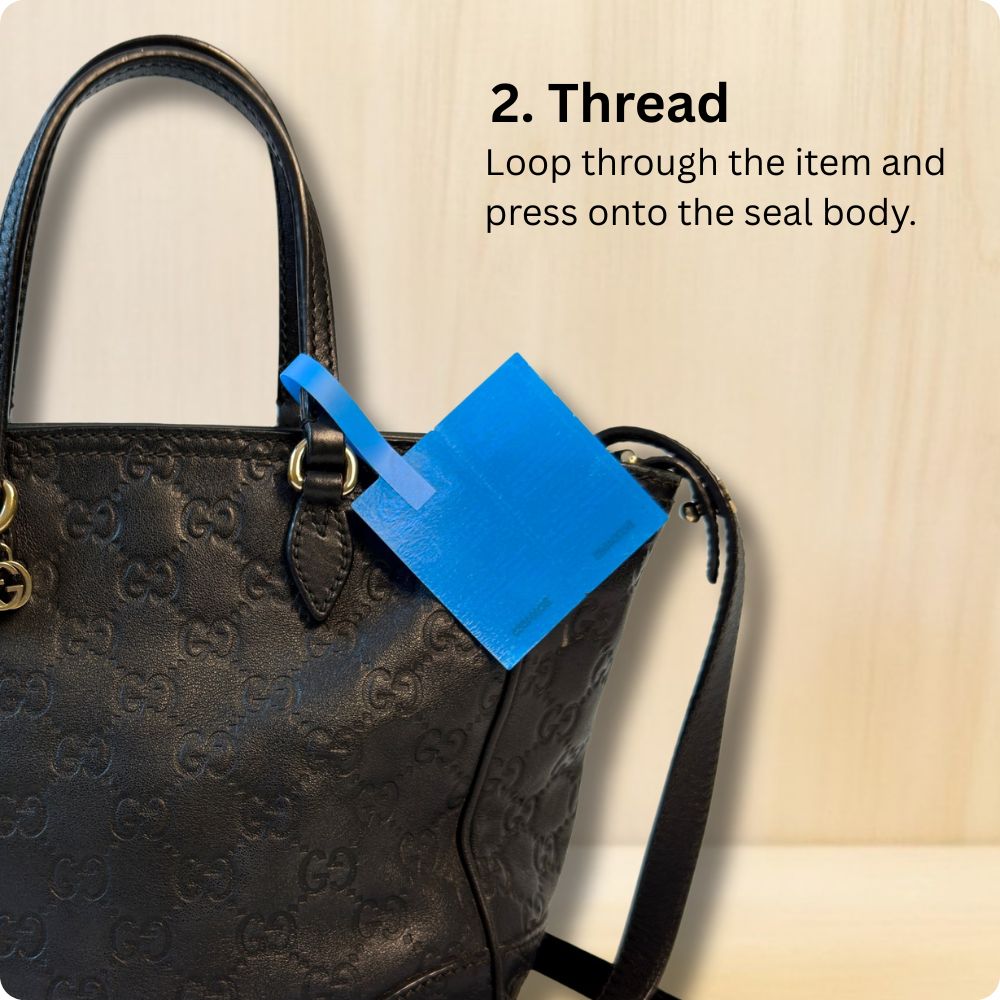 Attaching a 360 SureSeal Large to a handbag to stop e-commerce return fraud. Return integrity tag.