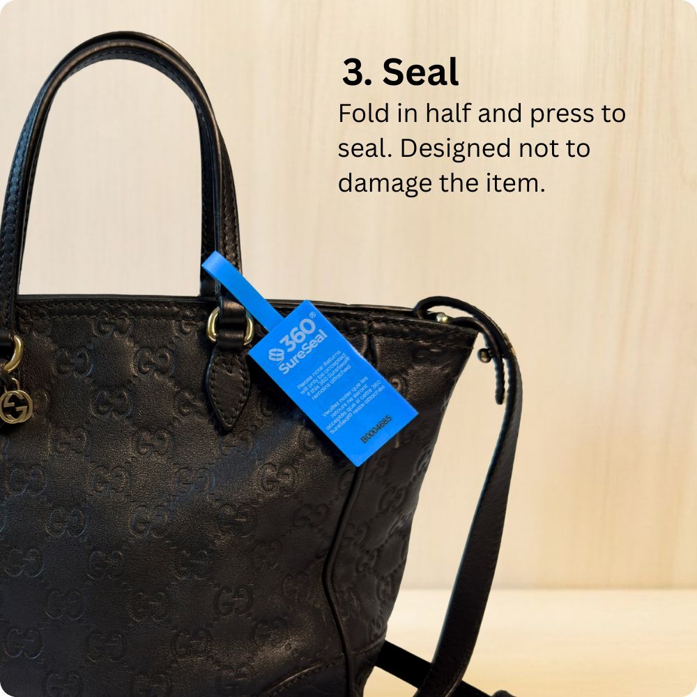 Attaching a 360 SureSeal Large to a handbag to stop e-commerce return fraud. Return integrity tag.
