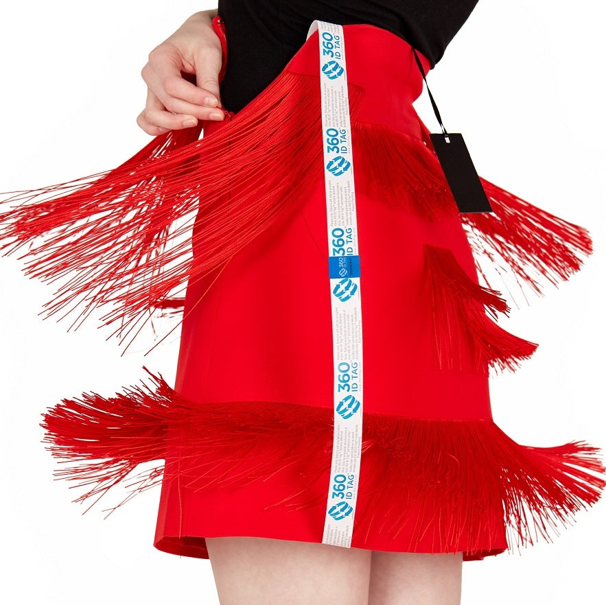 E-commerce return security tag on skirt. Prevent return fraud like wardrobing, wear and return, counterfeit product switches and tag switches. Add return tag to clothing, shoes, accessories to stop fraudulent returns. 360 ID Tag.