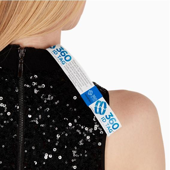 E-commerce return security tag on dress. Prevent return fraud like wardrobing, wear and return, counterfeit product switches and tag switches. Add return tag to clothing, shoes, accessories to stop fraudulent returns. 360 ID Tag.