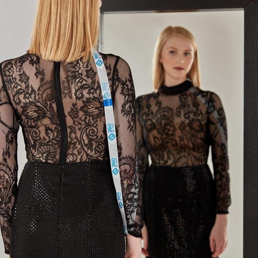 E-commerce return security tag on dress. Prevent return fraud like wardrobing, wear and return, counterfeit product switches and tag switches. Add return tag to clothing, shoes, accessories to stop fraudulent returns. 360 ID Tag.