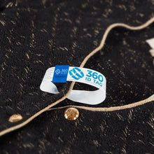 Load image into Gallery viewer, E-commerce return security tag through jacket button hole. Prevent return fraud like wardrobing, wear and return, counterfeit product switches and tag switches. Add return tag to clothing, shoes, accessories to stop fraudulent returns. 360 ID Tag.